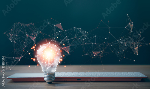 A light bulb and keyboard. The idea of ​​inspiration from online technology. innovation idea concept. Business brainstorm for solve solution, future ideas for startup, creativity and imagination.