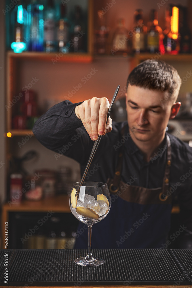 Bartender gently decorating cocktail glass