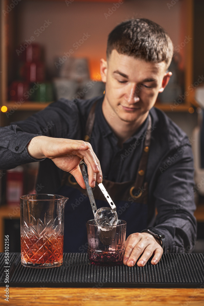 Bartender making negroni cocktail