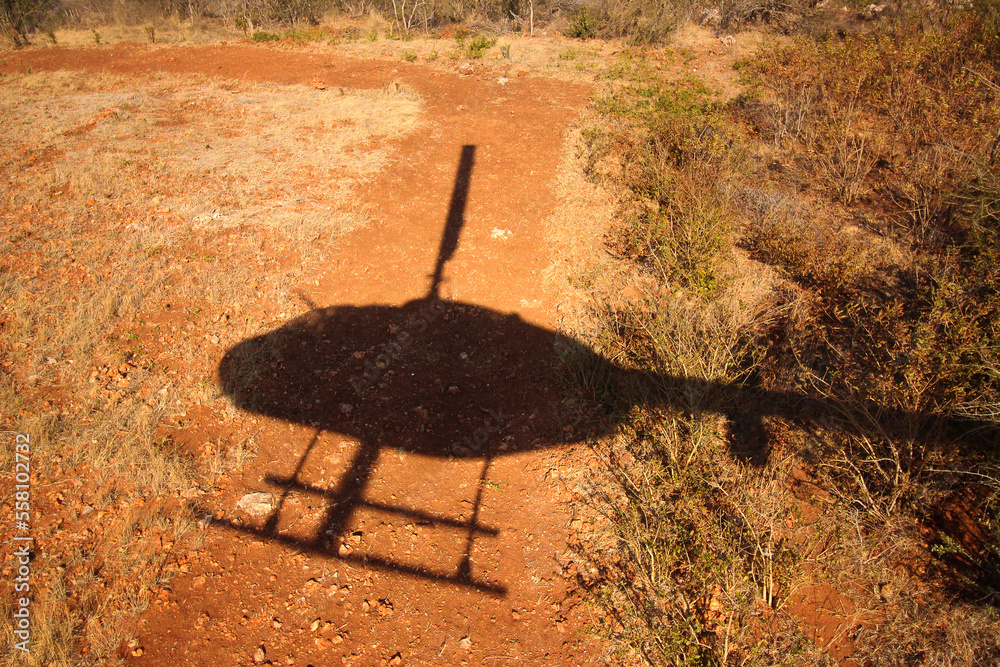 Shadow of a helicopter flying over bushveld desert