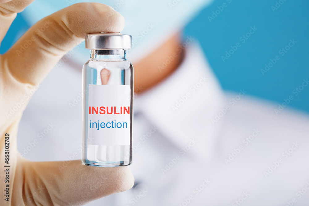 Diabetes treatment a bottle of insulin and a syringe with a needle in the hands of a doctor Diabetes treatment a bottle of insulin and a syringe with a needle in the hands of a doctor