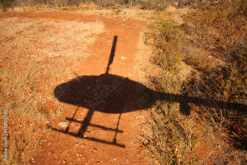 Obraz na płótnie Shadow of a helicopter flying over bushveld desert w salonie