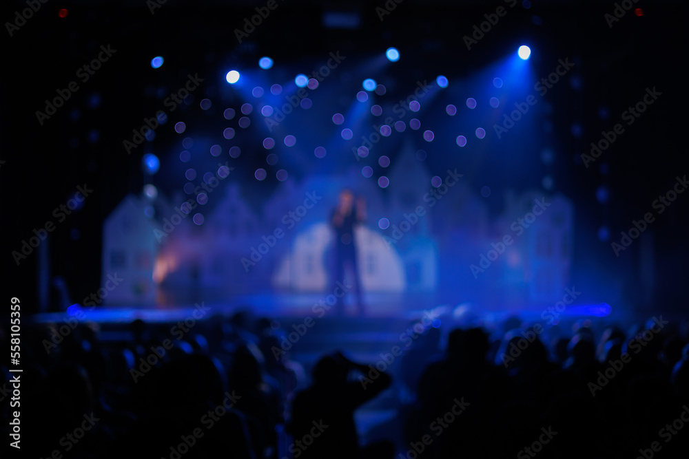 Texture blur and defocus, background for design. Stage light at a concert show. Singers, musicians and dancers perform on scene.