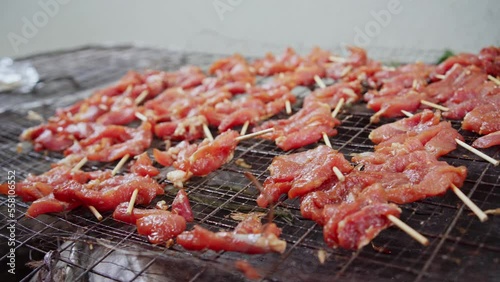 Thai sun-dried pork (Moo Dad Deaw) skewer preparation for local street food