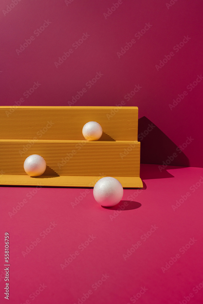 Yellow paper podium with white balls on magenta background. Minimal concept.
