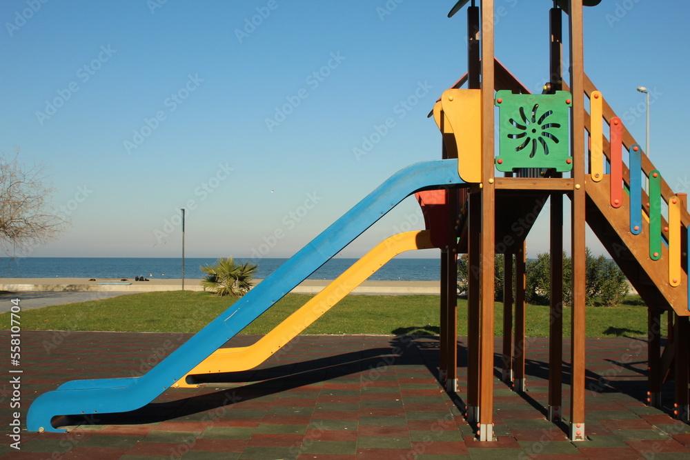Fototapeta premium Blue and yellow slide at park