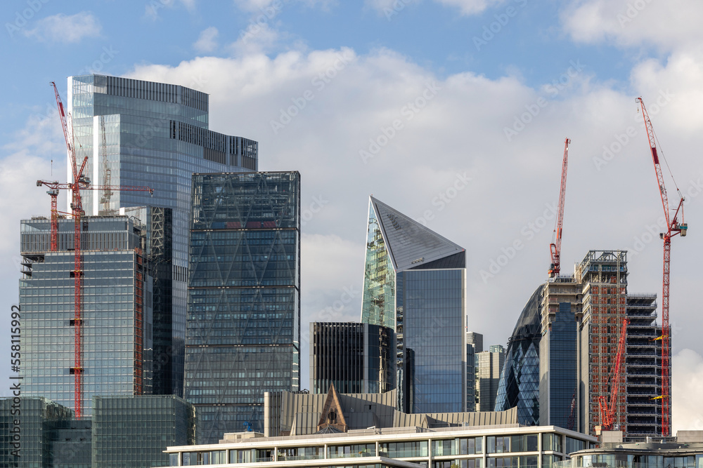 Obraz premium Modern steel and glass towers and buildings, multiple floored office spaces reaching for the sky in London, UK