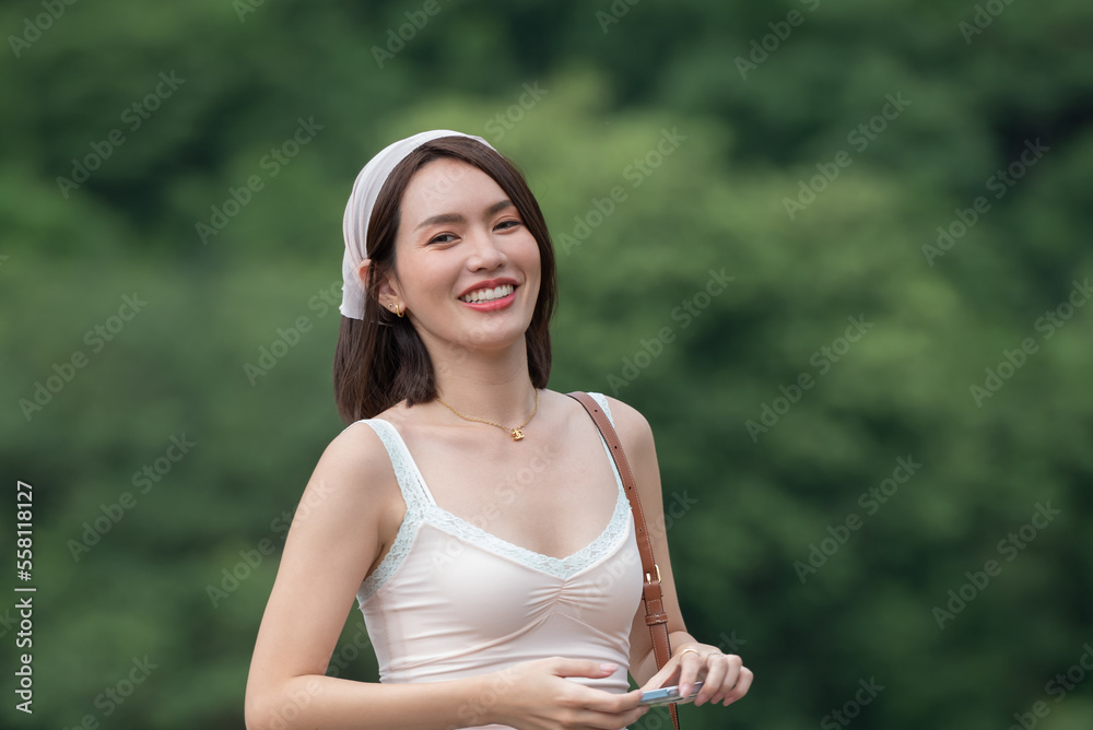 Woman smiling with perfect smile and white teeth in a park and looking at camera, Portrait of beautiful woman smiling and looking away at park during sunset. Happy cheerful girl laughing at park. Woman smiling with perfect smile and white teeth in a park and looking at camera, Portrait of beautiful woman smiling and looking away at park during sunset. Happy cheerful girl laughing at park.