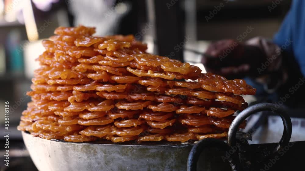 Making or cooking of Jalebi is a sweet Indian sweetie with syrup fried out in oil. Street food for Diwali in Kullu Manali Himachal Pradesh India.