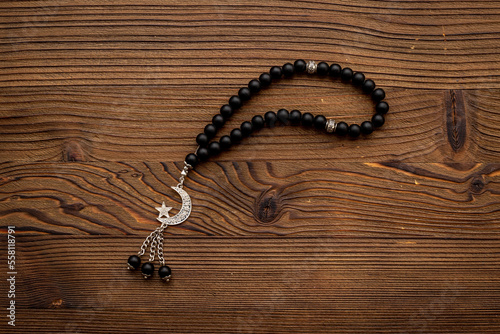 Islamic background with Muslim rosary and silver crescent moon