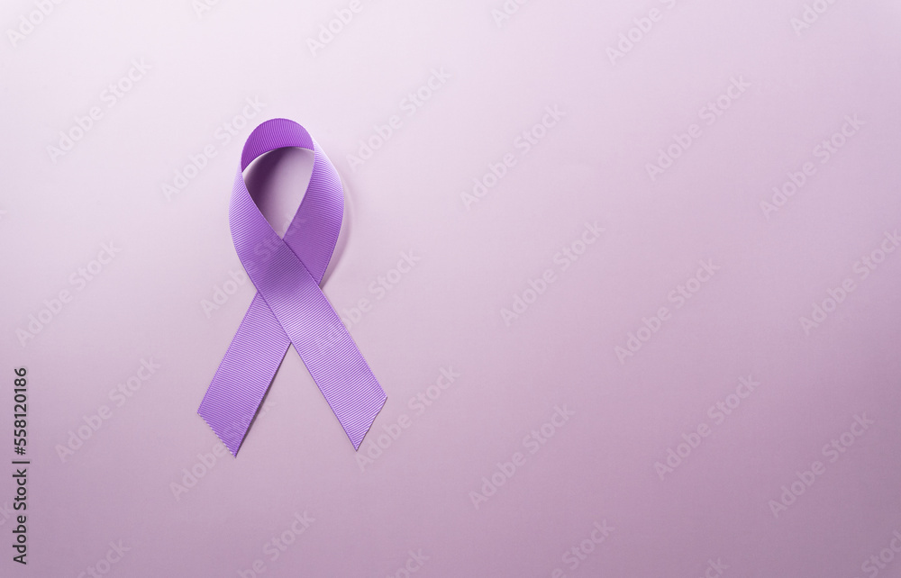 Purple ribbon on pastel paper background for supporting World Cancer Day campaign on February 4.