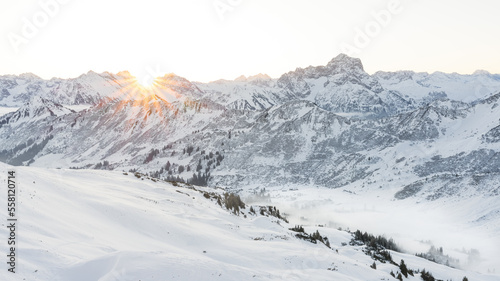 Valley view of the Kleinwalsertal in winter with fresh snow and blue sky. Austria Allg  u Alps