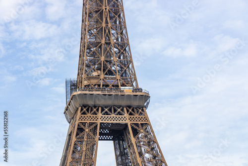 Second floor of the Eiffel Tower on sunny day with protective nets and tourists on the balconies