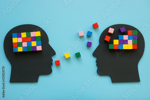 Heads with colorful cubes as symbol of mentoring and psychotherapy. photo
