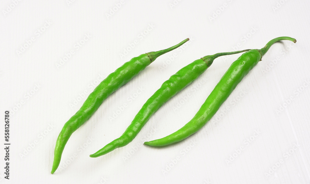 Fresh long Indian green chillies on wooden background. Fresh long Indian green chillies on wooden background.