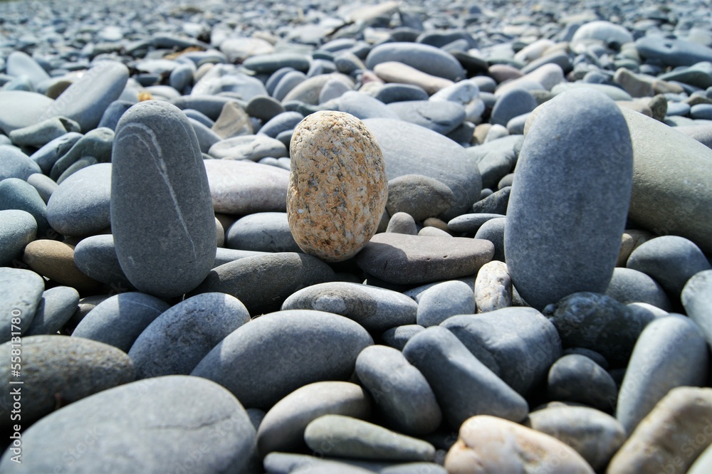 Three vertically placed stones on a rocky beach. Three vertically placed stones on a rocky beach.