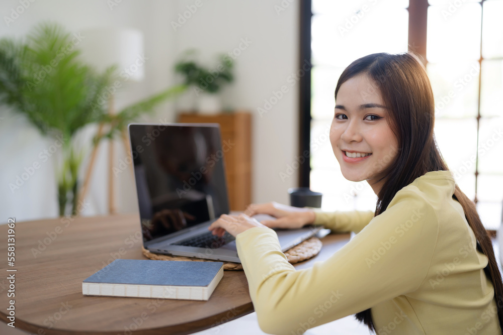 Asian woman working from home talking to colleagues in webcam group video call conference technology Asian woman working from home talking to colleagues in webcam group video call conference technology