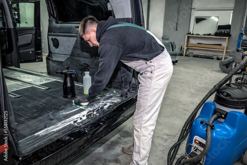 Car care concept, detailing and cleaning details. Worker using cleansing techonology for upholstery © Volodymyr Shevchuk