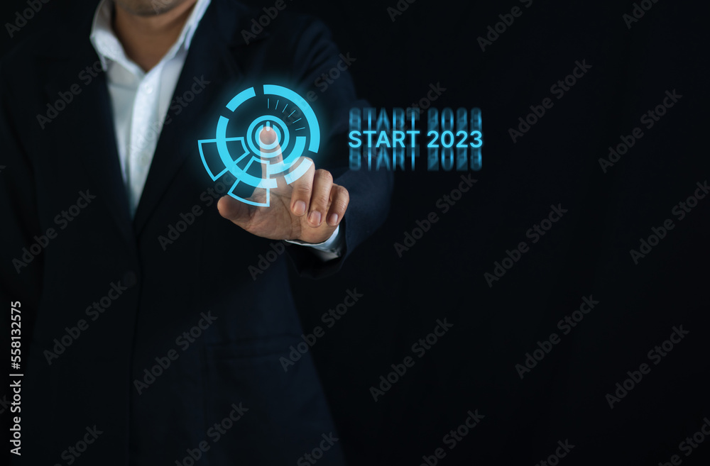 Businessman touching start button in 2023 Businessman touching start button in 2023