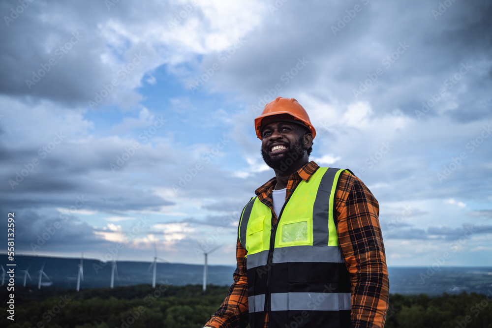 Portrait of engineer African American man working in wind turbine farm. Portrait of engineer African American man working in wind turbine farm.