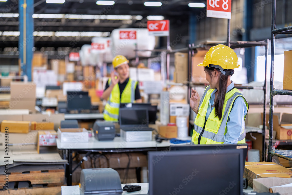 Worker working in the large depot storage warehouse concentrate check stock at cashier counter Worker working in the large depot storage warehouse concentrate check stock at cashier counter