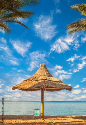 Morning on sandy beach with umbrella in Eilat - famous tourist resort in Eilat