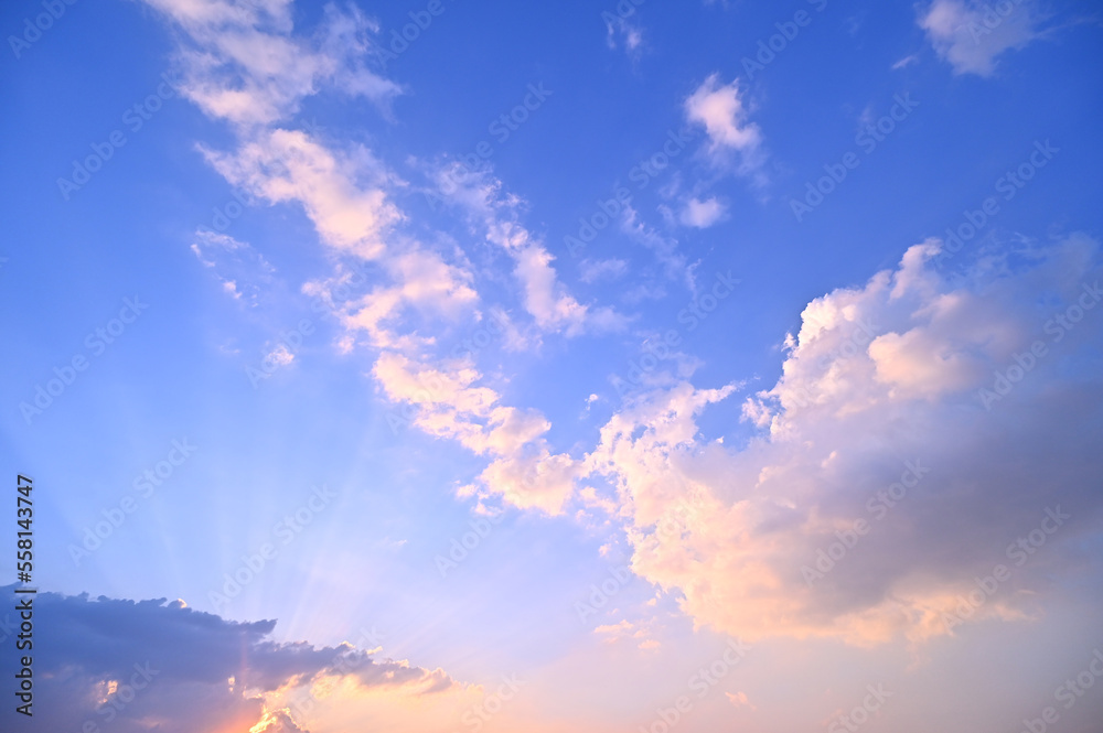 sunset or sun rise sky with rays of  light shining clouds and sky background and texture
