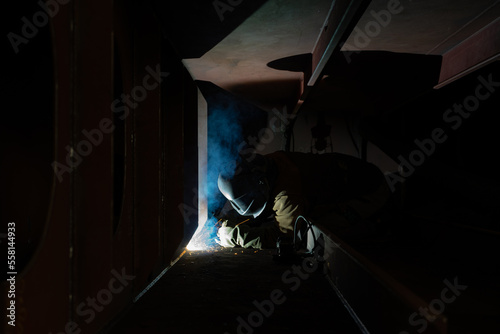 Welder welding in a shipyard a steelblock