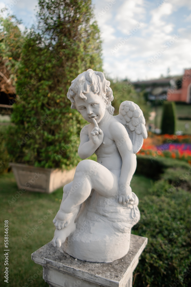 Statues in various postures placed in the garden