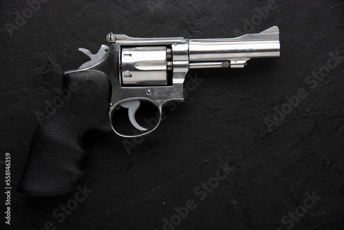 gun and bullets, Gun with ammunition and shackle on black background. top view