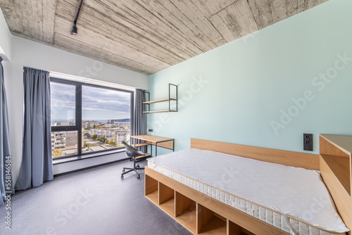 Simple student-style dorm bedroom. Hostel dormitory room. Campus © dechevm