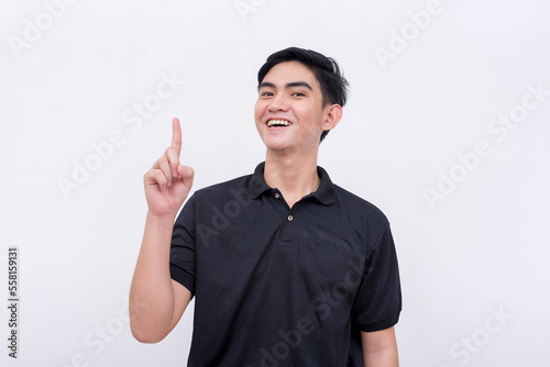 A cunning man having a eureka moment. Gesturing with his index finger, pointing upwards. Isolated on a white background.