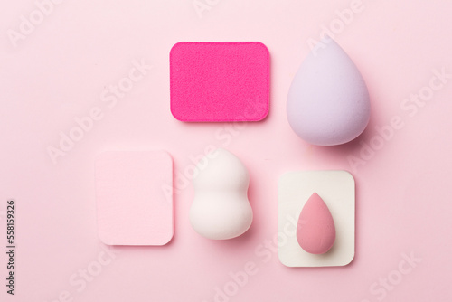 Beauty blenders on color background, top view