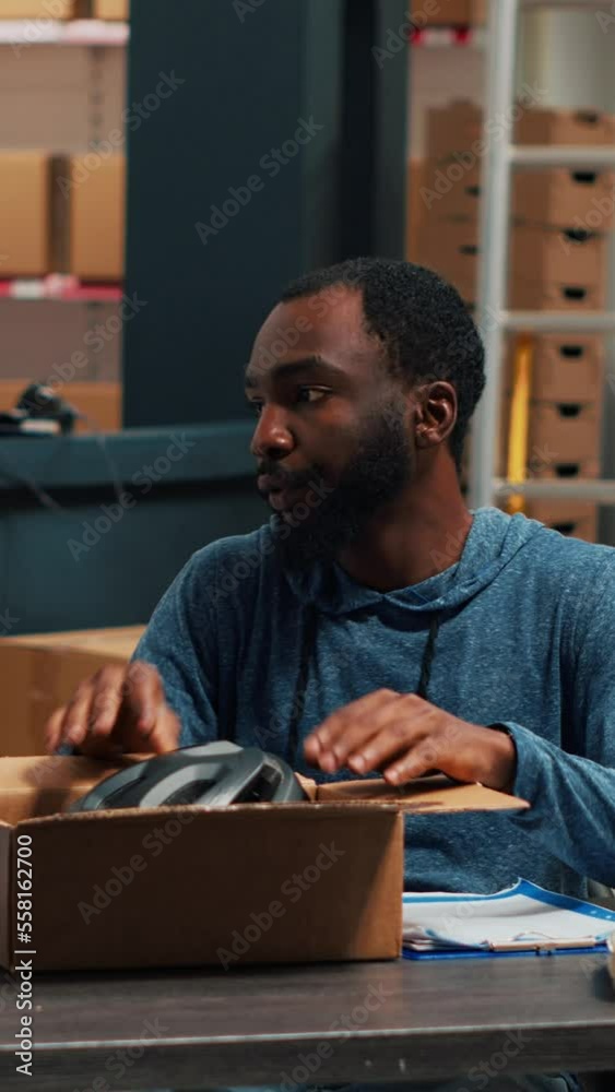 Vertical video: Diverse entrepreneurs planning order distribution and logistics, working on packaging and shipping. Man and woman delivering products and doing quality control, storehouse shelving Vertical video: Diverse entrepreneurs planning order distribution and logistics, working on packaging and shipping. Man and woman delivering products and doing quality control, storehouse shelving