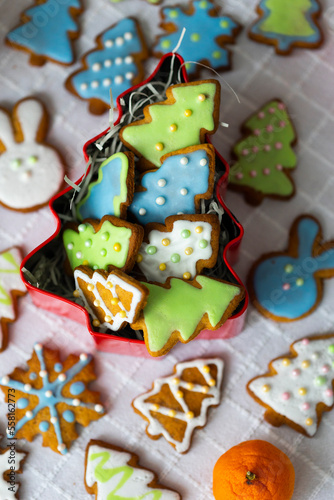 Ginger cookies in shape of rabbits,Christmas trees and snowflakes with sugar icing - light blue, green, white.