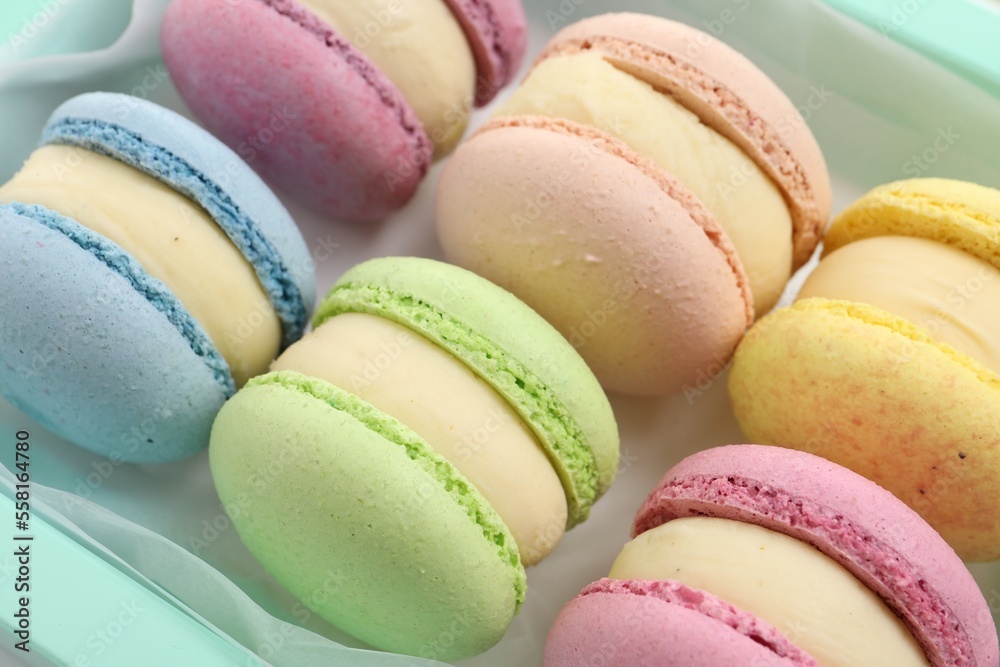 Many delicious colorful macarons in box, closeup Many delicious colorful macarons in box, closeup