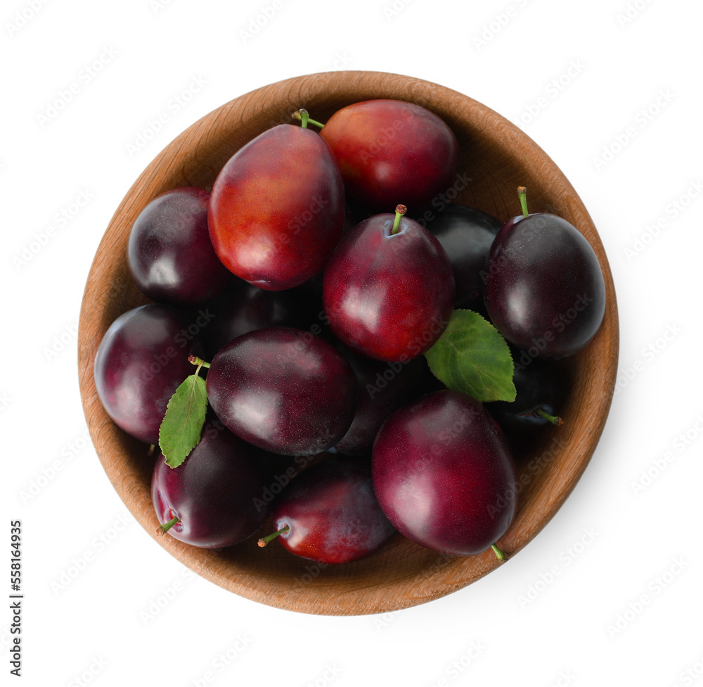 Bowl of delicious ripe plums on white background, top view