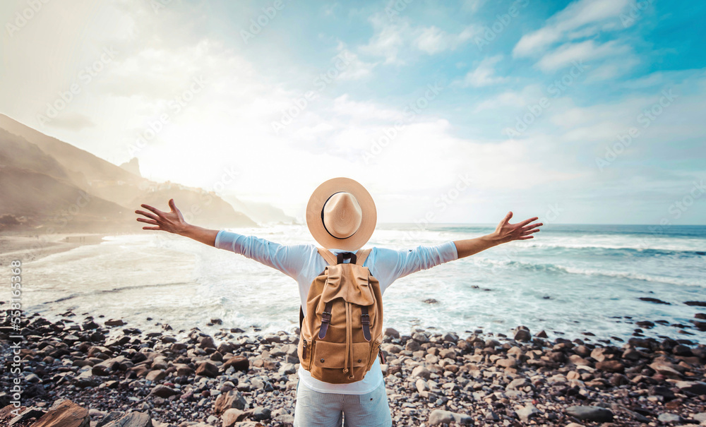 © Davide Angelini - Happy tourist with backpack enjoying freedom raising arms up © Davide Angelini - Happy tourist with backpack enjoying freedom raising arms up