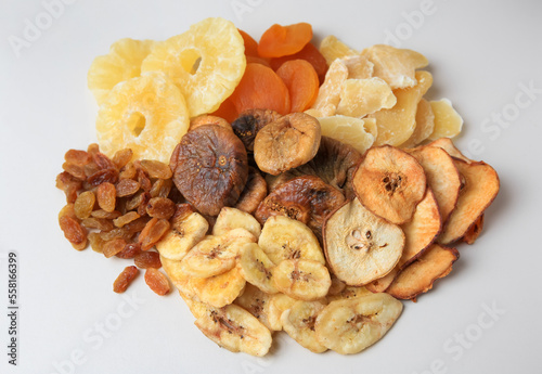 Pile of different dried fruits on white background, top view