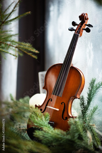 Vintage retro violin on a table, decorations, Christmas trees, candles, fabulous atmosphere