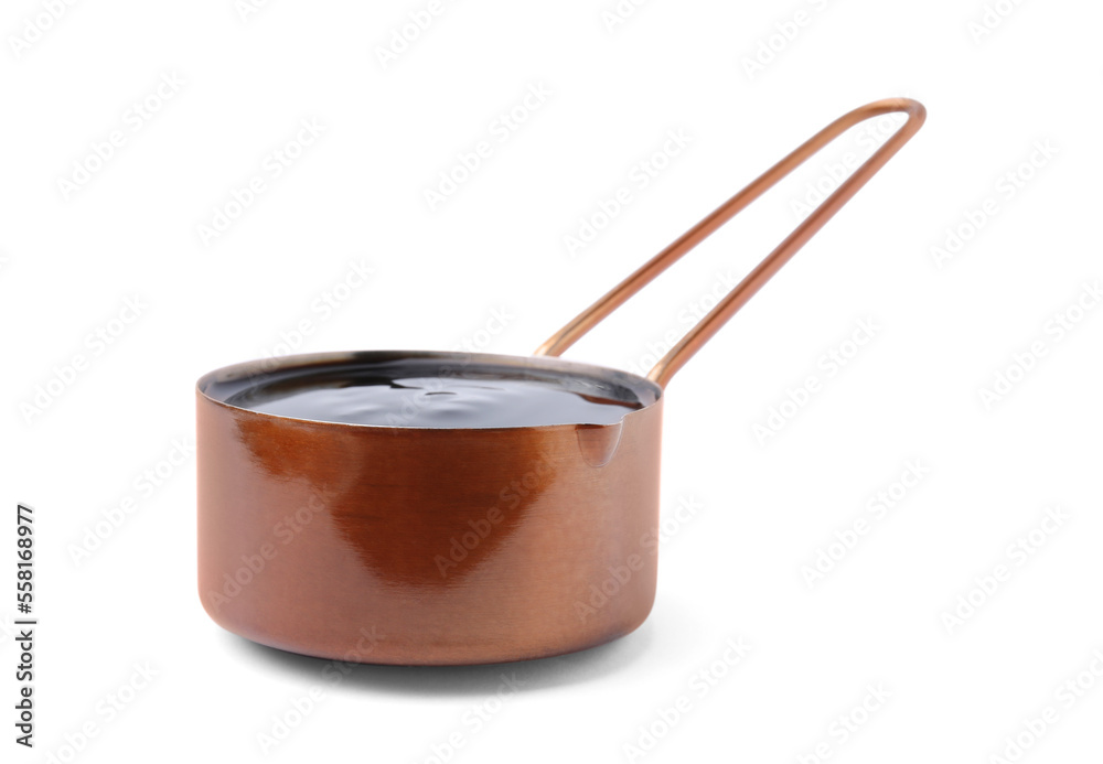 Metal small saucepan with balsamic glaze on white background Metal small saucepan with balsamic glaze on white background