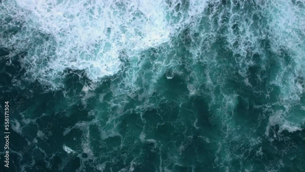 Top aerial view of ocean waves splashing against rocks background. High quality 4k footage Top aerial view of ocean waves splashing against rocks background. High quality 4k footage