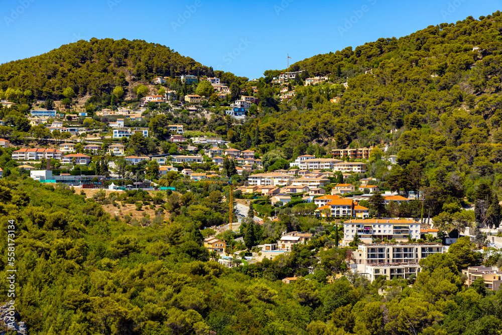 Panoramic view of Eze town valley among Alpes hills and residential area with summer houses and villas on French Riviera Coast of Mediterranean Sea in France