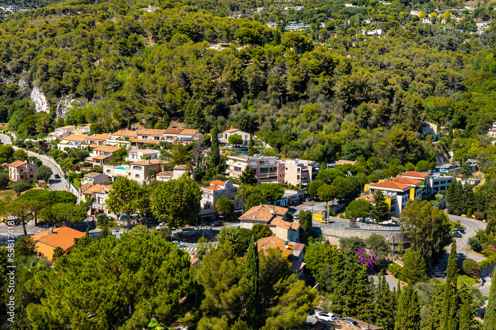 Panoramic view of Eze town center in valley among Alpes hills and summer villas on French Riviera Coast of Mediterranean Sea in France