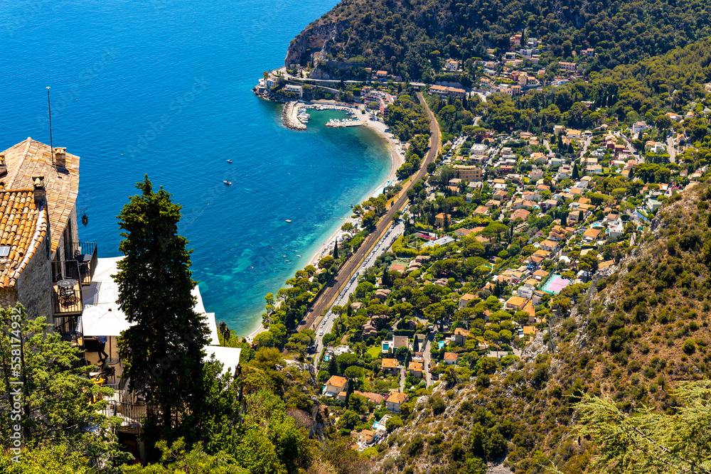 Panoramic view of Eze Bord de Mer and Silva Maris yacht port seen from historic town of Eze rising over Azure Cost of Mediterranean Sea in France