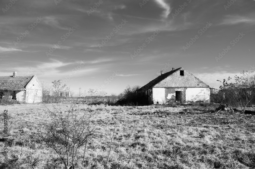 Abandoned old house with dramatic sky. Black and white photo. Abandoned old house with dramatic sky. Black and white photo.