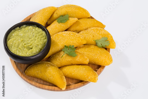 Colombian empanada with avocado sauce - on the white background.traditional colombian food