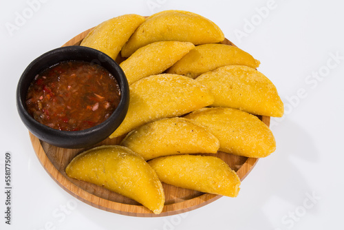 Colombian empanada with spicy sauce - on the white background.traditional colombian food