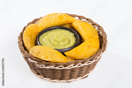 Colombian empanada with avocado sauce - on the white background.traditional colombian food