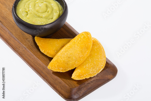 Colombian empanada with avocado sauce - on the white background.traditional colombian food
